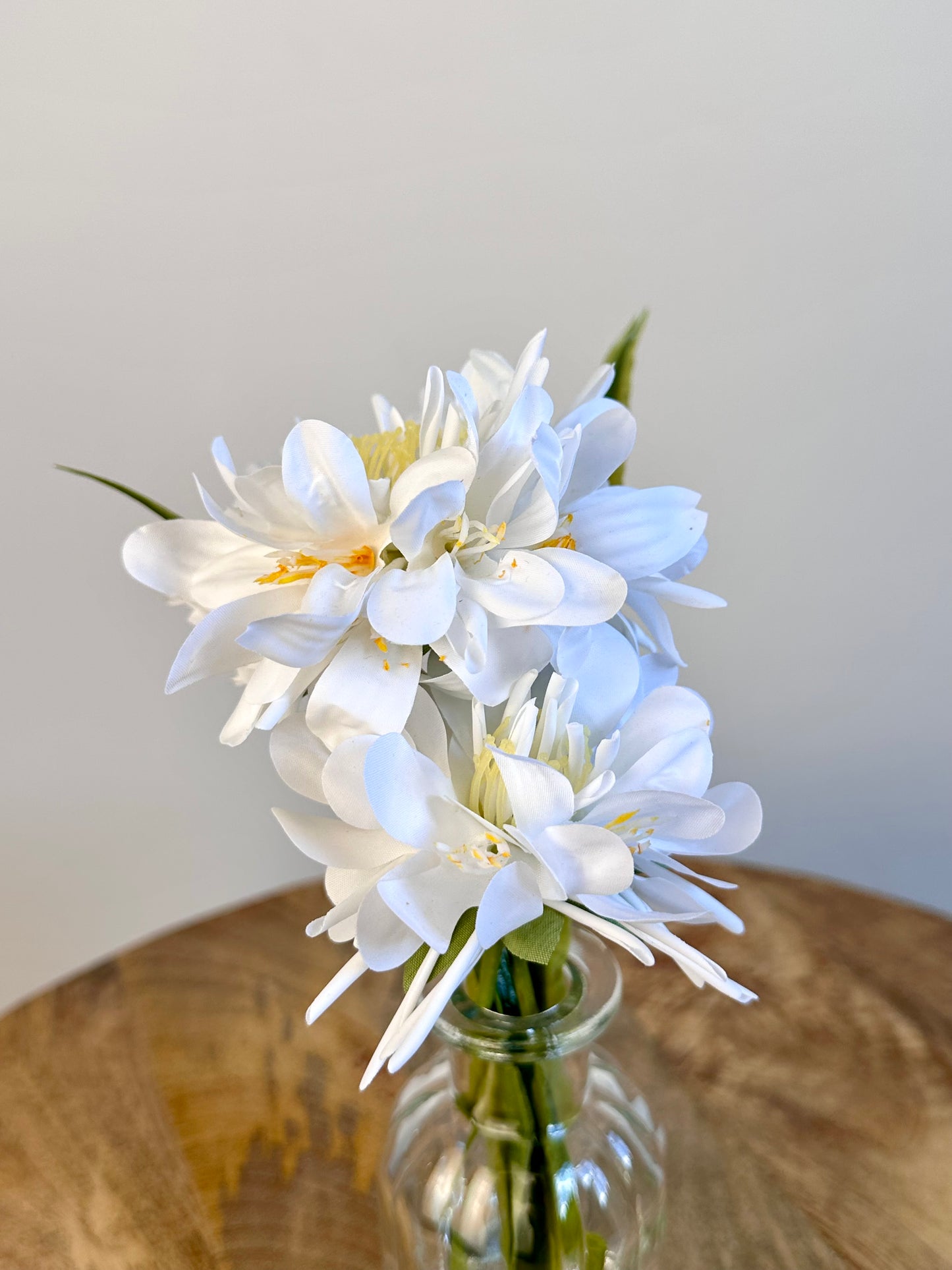 White Floral Display In Clear Glass Ribbed Jar 21cm