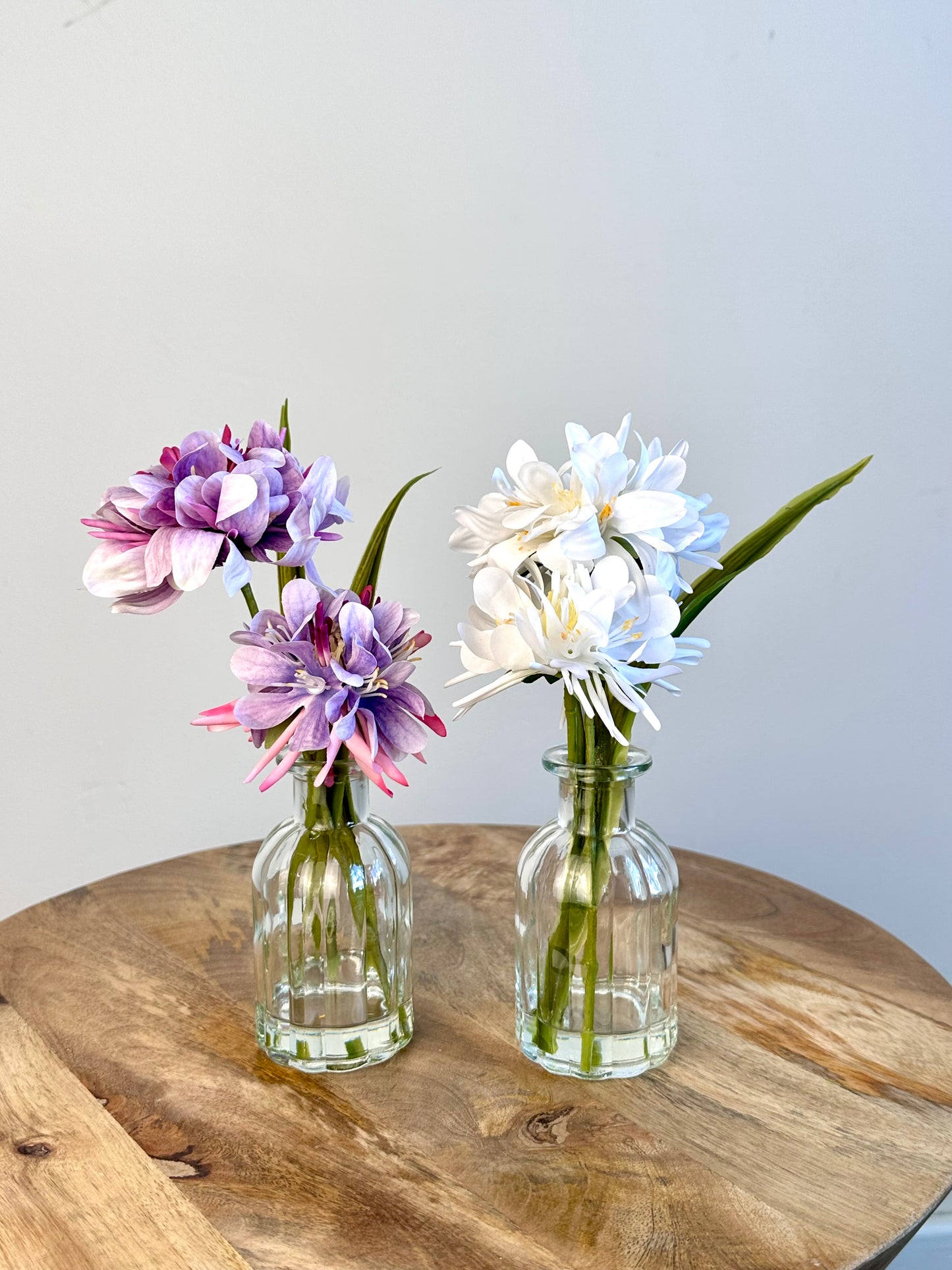 White Floral Display In Clear Glass Ribbed Jar 21cm